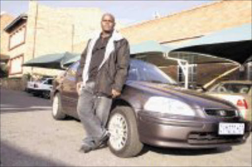 Amos Mulaudzi stands next to his car. He says the difference between his car and the clone that has been getting traffic fines is that his car has a tow bar, the other one does not. PHOTO:VATHISWA RUSELO