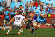 Luke Morgan of the Ospreys looking to tackle a charging Reinhardt Ludwig of the Vodacom Blue Bulls during the United Rugby Championship match at Loftus Versfeld.