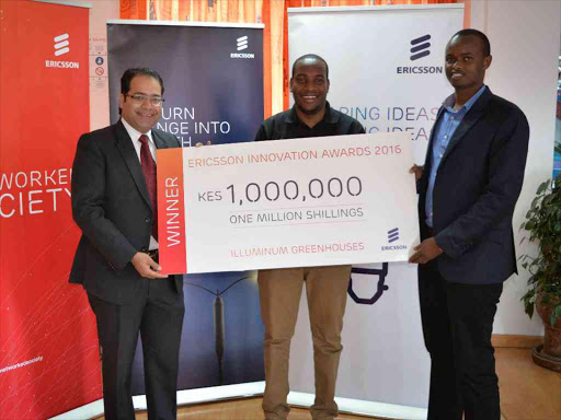 Ericsson Kenya managing director Aakaash Seghal hands a $10,000 dummy cheque to lluminum Greenhouses co-founders Taita Ngetich and Brian Bett, who won the Ericsson Innovation Award for sub-Saharan Africa. /COURTESY