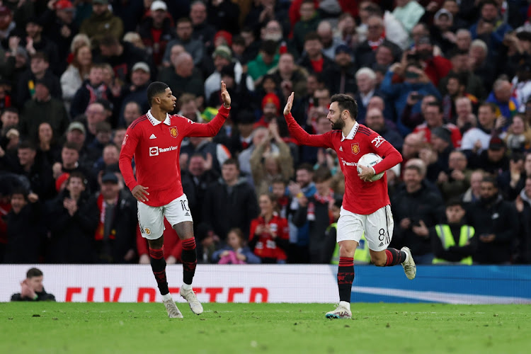 Bruno Fernandes of Manchester United celebrates with Marcus Rashford after scoring the team's first goal in the FA Cup quarterfinal against Fulham at Old Trafford on March 19 2023.
