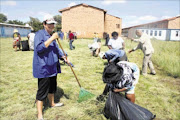 LEADING BY EXAMPLE: Gauteng education MEC Barbara Creecy leads the clean-up team at Bokamoso Secondary School in Thembisa yesterday ahead of the start of the school term on Wednesday. Pic. MUNYADZIWA NEMUTUDI. 10/01/2010. © Sowetan.