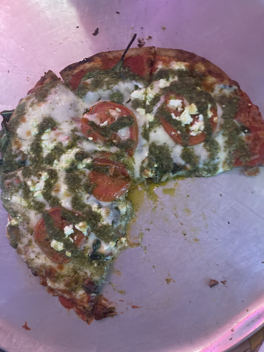 Partially eaten Kosmic Karma pizza