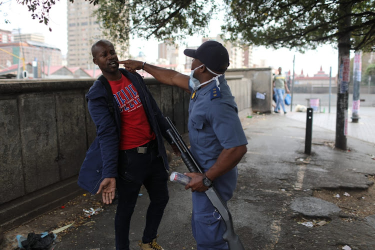 A member of the SAPS calling a Hillbrow resident to order and to follow lockdown regulations. Judge Norman Davis on Tuesday issued a scathing assessment of the government's lockdown laws in the North Gauteng High Court.