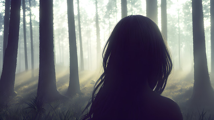 A girl walks through a forest