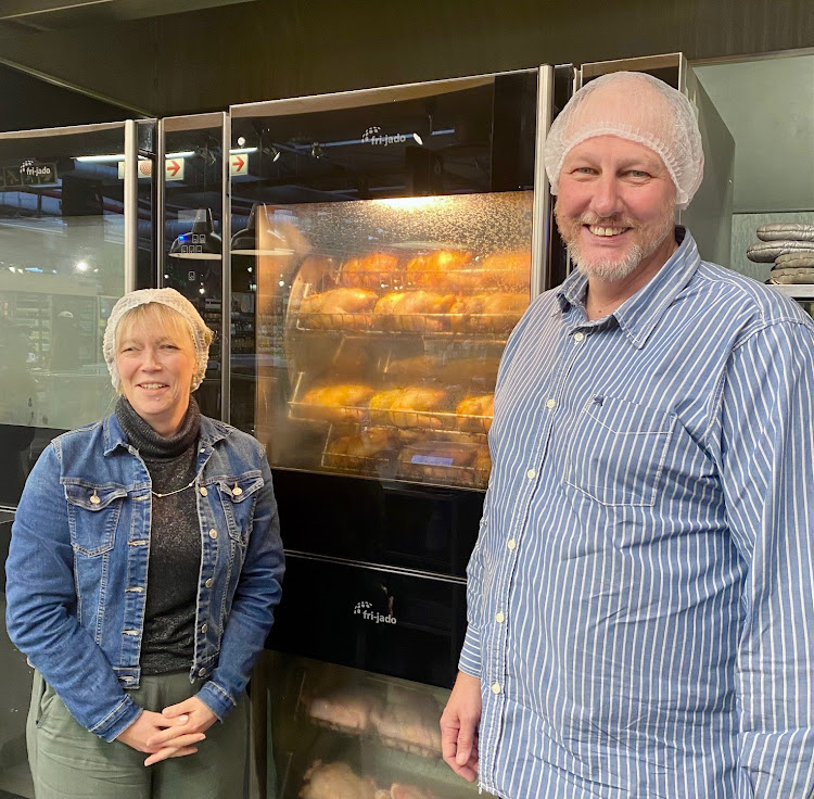 Zelda and Wilthur Nell at the source of their biodiesel - the Woolworths rotisserie oven. Diesel vehicles can run on biodiesel made from the fat that drips off rotisserie chickens while they cook.