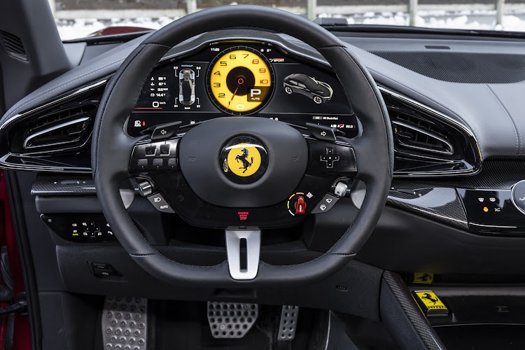 Several driving modes can be set by the “Manettino” rotary switch on the steering wheel, and the car’s functions are accessed via a mix of physical and digital controls. Picture: SUPPLIED