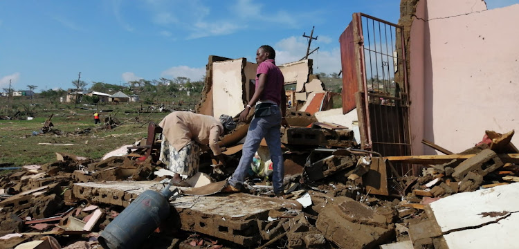 Residents try to salvage their possessions after a tornado struck Mpolweni in the KwaZulu-Natal Midlands on Tuesday.