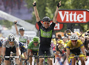 Team Sky's Edvald Boasson Hagen of Norway (C) celebrates winning the sixth stage ahead of HTC-Highroad's Matthew Goss of Australia (L) and Garmin-Cervelo's Thor Hushovd of Norway, at the Tour de France, from Dinan to Lisieux, July 7, 2011