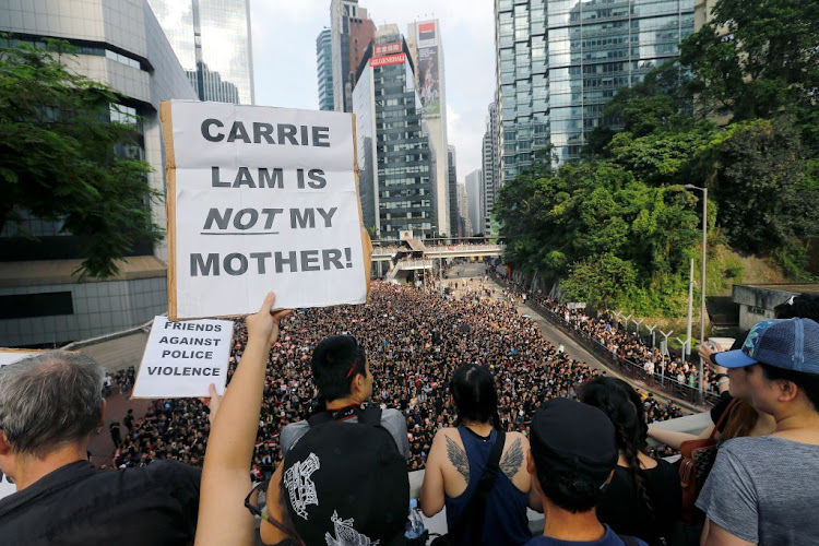 Protesters hold placards as they attend a demonstration demanding Hong Kong's leaders to step down and withdraw the extradition bill, in Hong Kong, China, on June 16 2019.
