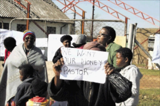 DISAFFECTED: Congregants of the Full Gospel Church, Rock Praise Centre Assembly in Rockville, Soweto, protest outside the church building yesterday demanding that their pastor be relocated, accusing him of mismanagement of funds. Pic: Munyadziwa Nemutudi. 13/06/2010. © Sowetan.