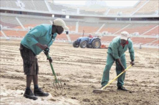 PROGRESS: Turftek workers prepare the pitch at the Peter Mokaba Stadium in Limpopo for the 2010 World Cup final in June. Pic. Elijar Muxhiana. 24/03/2010. © Sowetan.