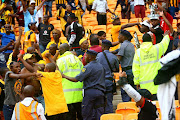 Chiefs and  Pirates supporters  fighting  during the Telkom Knockout Semi Final match between Kaizer Chiefs and Orlando Pirates at FNB Stadium.   Photo. Veli Nhlapo.@ Sowetan