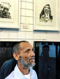 Joseph Buys, an inmate at Drakenstein Correctional Services in Paarl (formerly Victor Verster Prison) with two of his etchings that can be seen at the 'Identity' exhibition in Cape Town