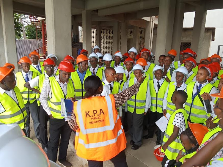 Pioneer School students being taken through the Mombasa Port operations by a Kenya Ports Authority official.
