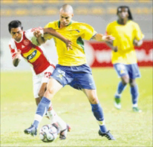 SHIELDING: Mamelodi Sundowns' Dillon Sheppard and Ajax Cape Town's Sameehg Doutie battle for the ball during their Premiership match at Athlone stadium in Cape Town on Saturday. 20/12/08. Photo: Ron Gaunt. © Unknown.