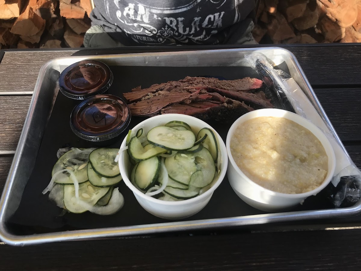 Brisket platter with cucumbers and cheddar grits