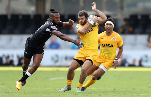 Sharks's Lukhanyo Am (L) tackles Jaguares Santiago Cordero (C) during the Super XV rugby union match between Sharks and Jaguares at Kingspark Rugby Stadium on April 8, 2017, in Durban.