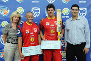 Master blaster bowler, Ethan O'Reilly and Master blaster batter, Robert Frylinck receive their cheques from Anne Vilas (GCB board member) and Victor Jordim (Standard Bank Regonal Manager) during the Standard Bank Pro20 match between bizhub Highveld Lions and Nashua Mobile Cape Cobras at Bidvest Wanderers Stadium on January 30, 2011 in Johannesburg, South Africa.