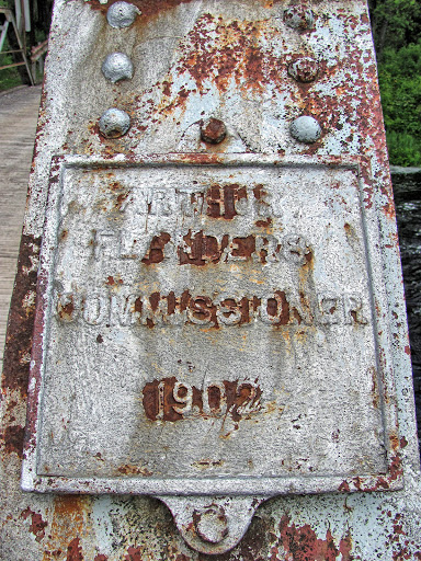      Arthur     Flanders Commissioner       1902 Name of the county highway commissioner and bridge's build date is on this nearly illegible plaque. Metal frame, wooden deck. South (upstream) of...