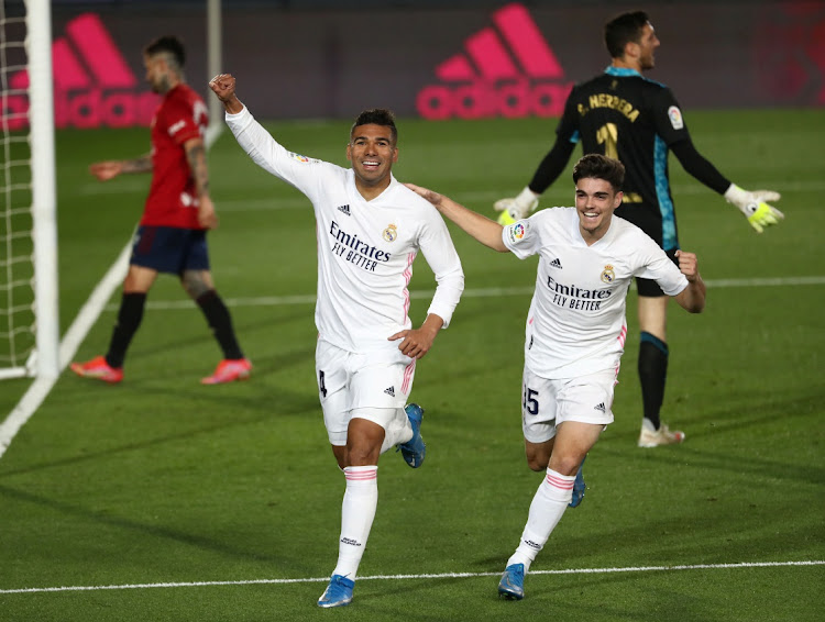 Real Madrid's Casemiro celebrates scoring their second goal with Miguel Ortega Gutierrez.