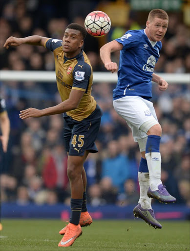 Arsenal’s Nigerian striker Alex Iwobi, left, vies for the ball with Everton’s Scottish-born Irish midfielder James McCarthy during yesterday’s English Premier League match at Goodison Park.