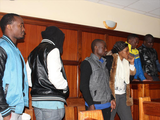 Cameroon nationals Amber Michael, Derrick Akebe, Erick Wankwe Fokola, Domsfu Buruma, Epiezitune Metuge, Ayafor Aiden Ayafur and Etchi Enongene in the Milimani courts yesterday /COLLINS KWEYU