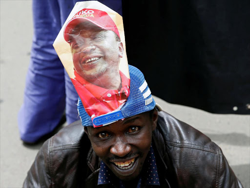 A Jubilee Party supporter cheers after Supreme Court upheld the re-election of President Uhuru Kenyatta in last month's repeat presidential vote, November 20, 2017. /REUTERS