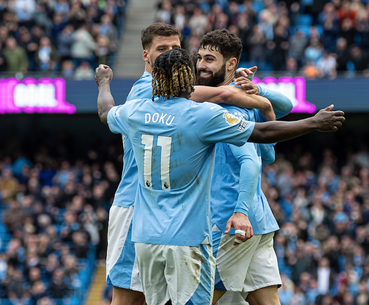 Man City's Josko Gvardiol (R) celebrates scoring with teammates during the English Premier League match.