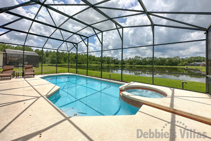 Sun-drenched west-facing pool and spa deck overlooking the lake at this Kissimmee vacation villa