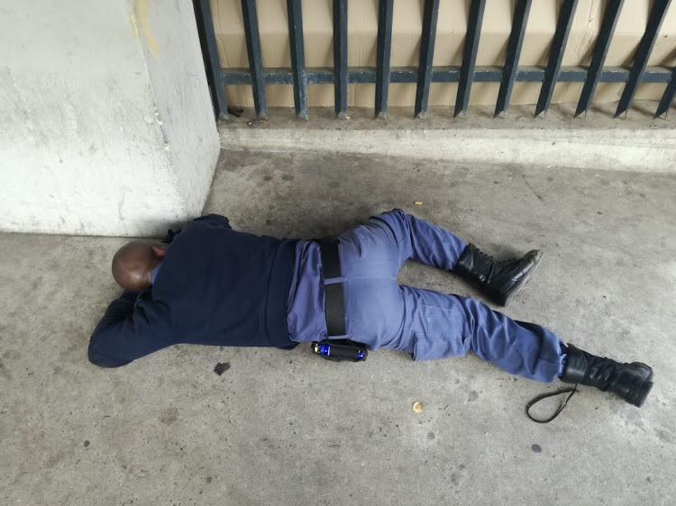 A police officer was found asleep on the floor at Durban’s Pavilion shopping centre on July 26, 2018.