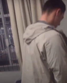 A screenshot from the video of Stellenbosch University student Theuns du Toit urinating on a black student's desk and belongings.