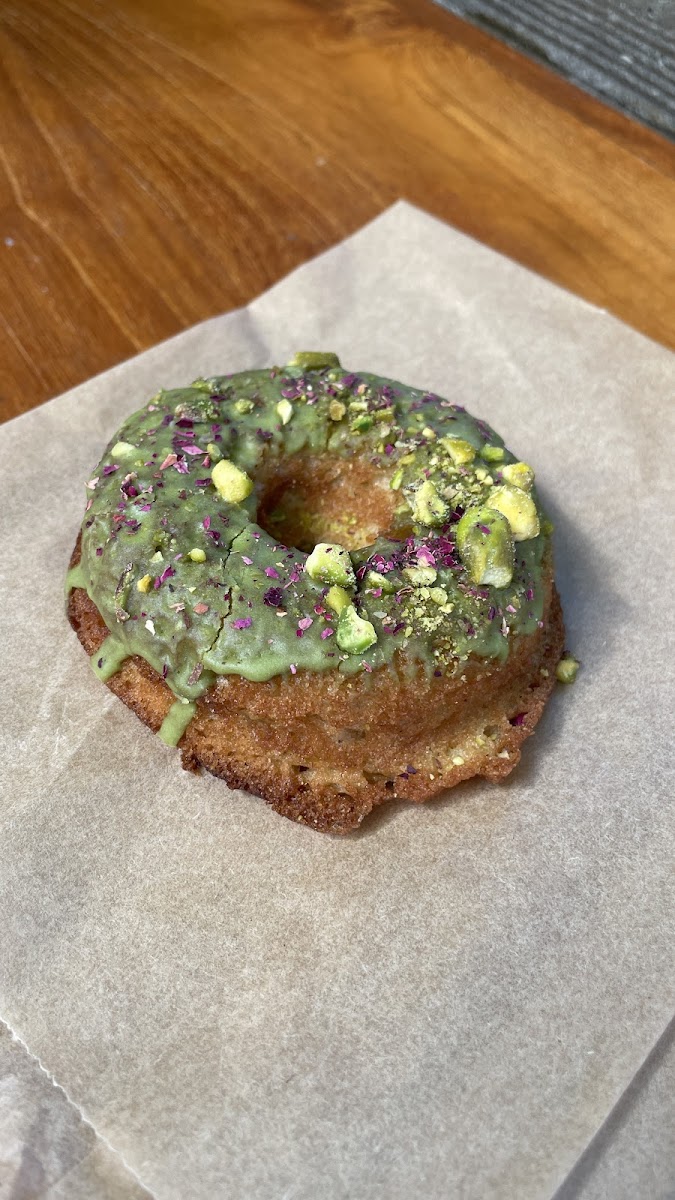 GF Matcha donut topped with crushed pistachios.