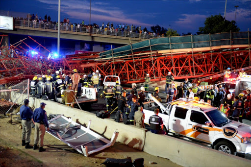 Ememrgency personnel at the accident scene after the collapse of a temporary pedestrian bridge next to Grayston Drive onto the M1 highway. Picture Credit: Gallo Images
