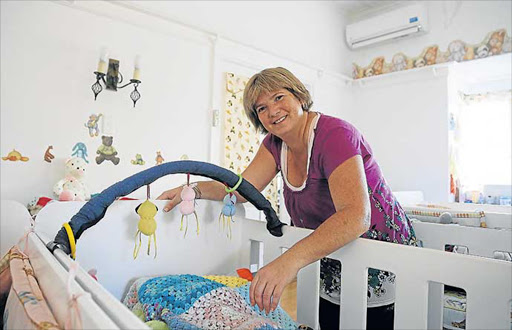 DEDICATED: Local hero Bev Gunton takes cares of a baby at the Breath of Life in Selborne