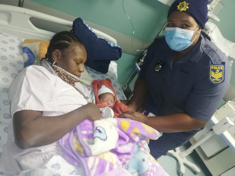 Sergeant Itumeleng Motalane with the mother and child she helped deliver.