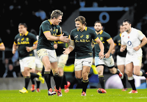 LASER-GUIDED: South Africa's Pat Lambie, right, celebrates with captain Jean de Villiers after kicking a drop goal during the Test match against England at Twickenham on Saturday