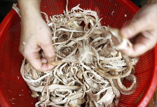 A chef prepares cooked snake for customers in a restaurant. File photo.