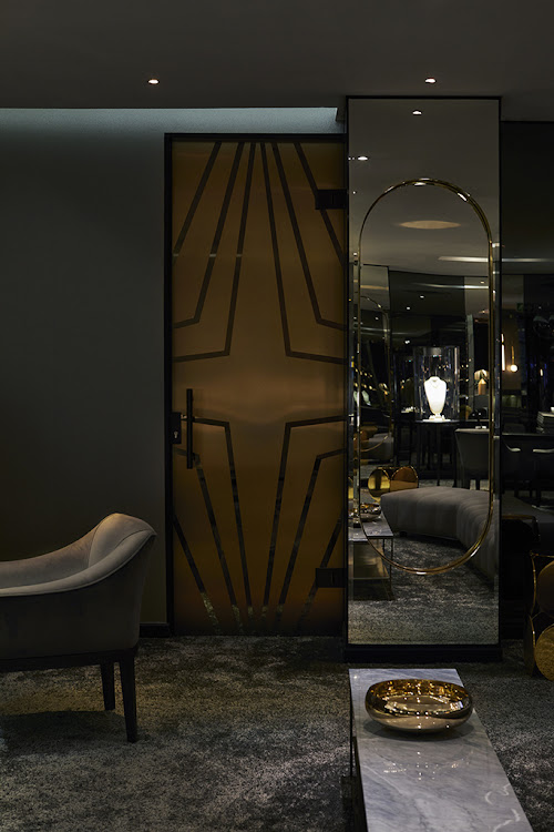 The smokey glass and brass door leading to the private consultation room was manufactured by Ernst H Design.