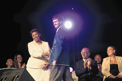 RISING STAR: Conrad Strydom, the top matric pupil of 2016, is congratulated by Basic Education Minister Angie Motshekga