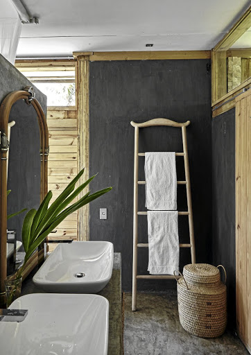 The rustic chic décor seen throughout the house continues into the ensuite bathroom.