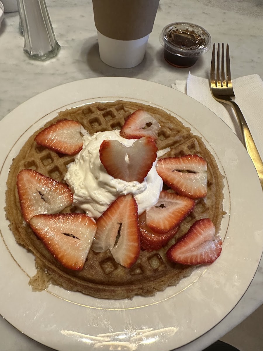 Waffles with optional whipped cream and strawberries.