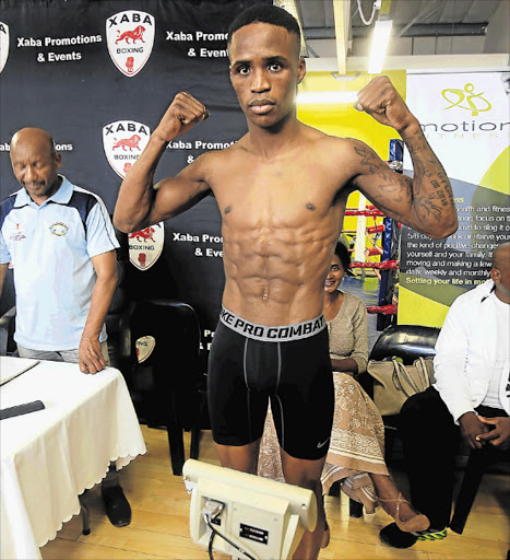 UPBEAT: Lusanda Komanisi at the final weigh-in ceremony held at Mdantsane Motion Fitness yesterday afternoon, ahead of his WBO intercontinental featherweight championship bout against unbeaten Filipino Jhack Tepora, which will be held at the Orient Theatre this evening Picture: SINO MAJANGAZA