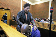 Siphiwe Khalishwayo  comforts her son's father Sibusiso Tshabalala    at the Lenasia Magistrate's Court after  he accidentally shot their son. The writer applauds her unwavering support.      /SANDILE NDLOVU