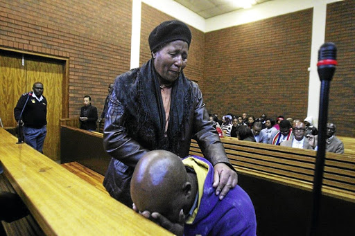 Siphiwe Khalishwayo comforts her son's father Sibusiso Tshabalala at the Lenasia Magistrate's Court after he accidentally shot their son. The writer applauds her unwavering support. /SANDILE NDLOVU