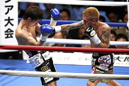 Hekkie Budler connects his right on Ryoichi Taguchi of Japan in a previous fight. / Getty Images / The Asahi Shimbun