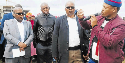 ATTENTIVE: Mayor Xola Pakati, left, hears grievances from angry Nompumelelo residents, who have been protesting over service delivery Picture: NAMHLA MBONGENDLU