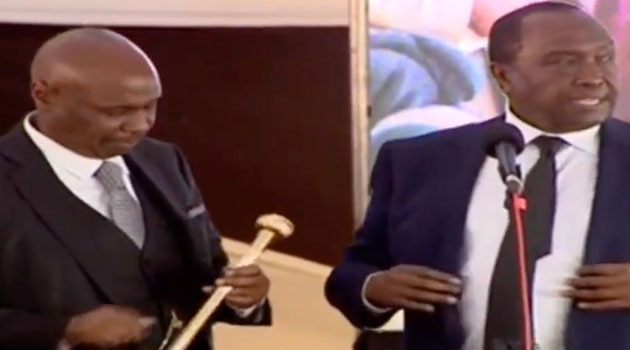 Gideon Moi stares at the baton after it was handed to him by Raymond his elder brother