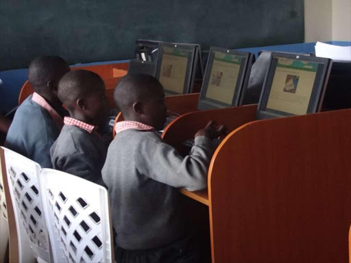 Students in Valley View Mathare slums using the a-ACADEMY content in a class lesson./FILE