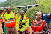 Chief provincial inspector Simon Kekana, transport & community safety MEC Florence Radzilani and transport minister Sindisiwe Chikung with with SAPS forensic officers on the bridge above the crash site.