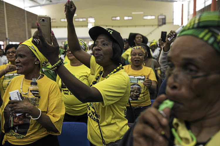 ANC supporters cheer party secretary-general Gwede Mantashe at a rally at Oscar Mpetha High School in Nyanga.